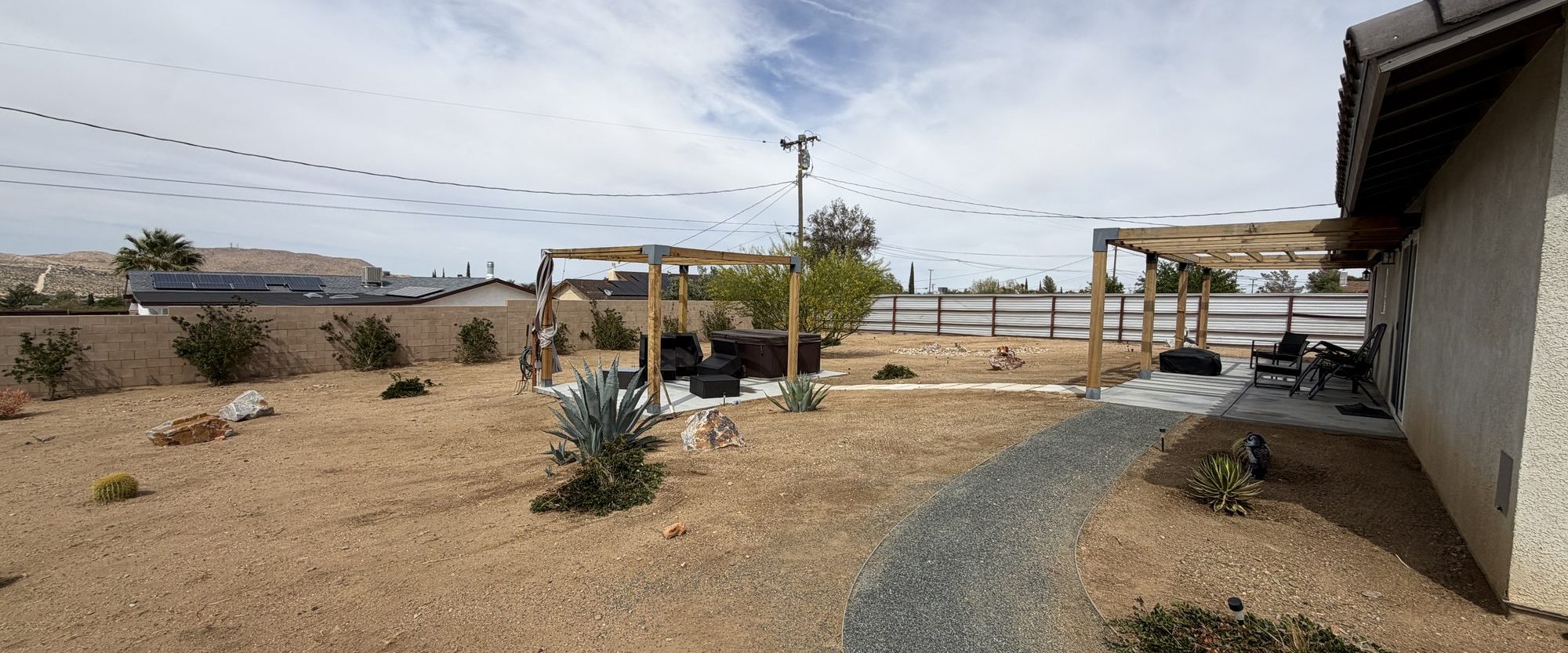 Pergola and decomposed granite path with desert plantings