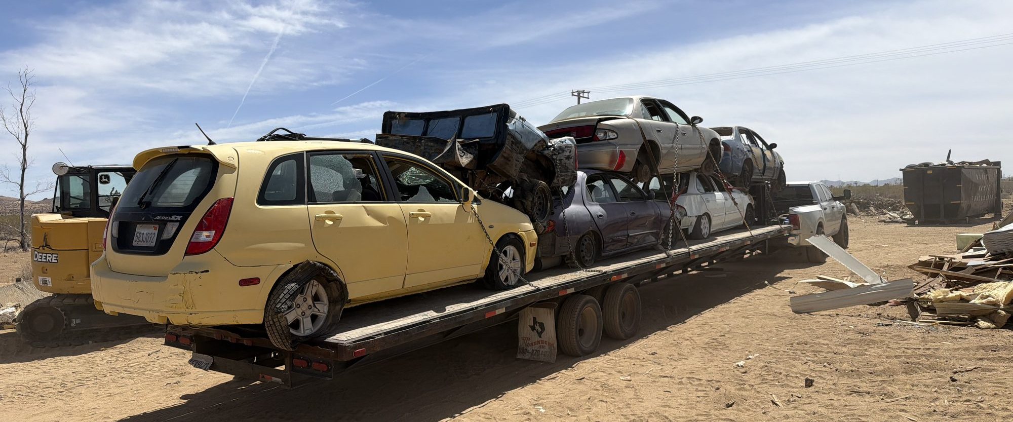 Car hauler loaded with scrap vehicles