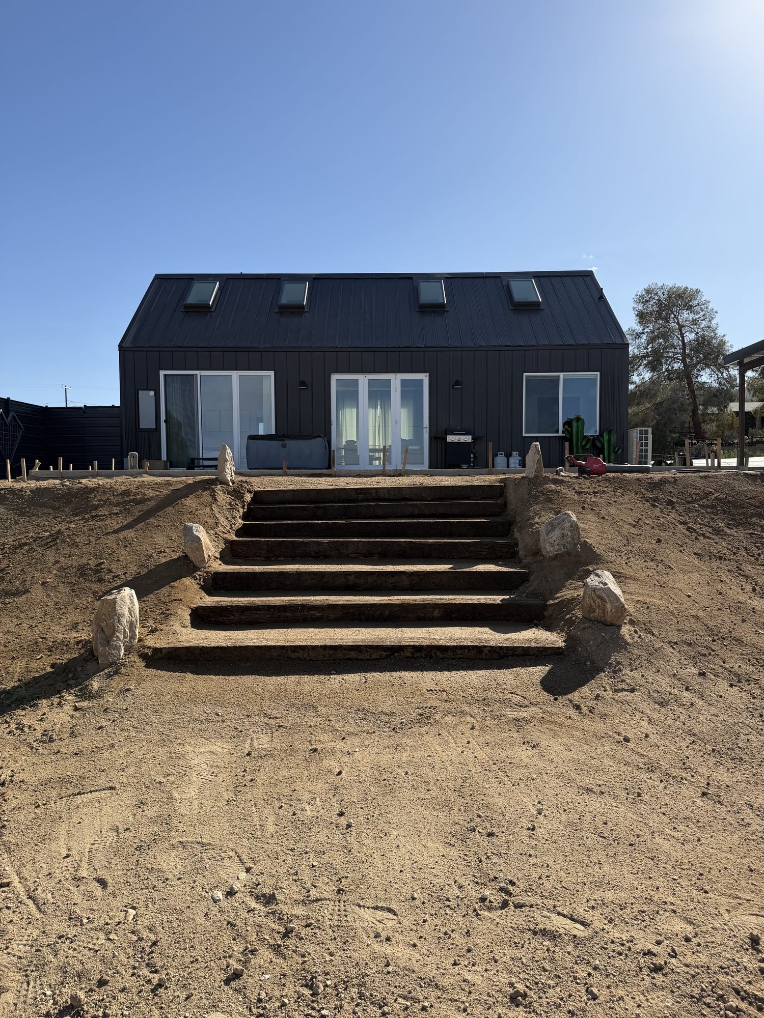 Finished timber step run with granite boulder edging