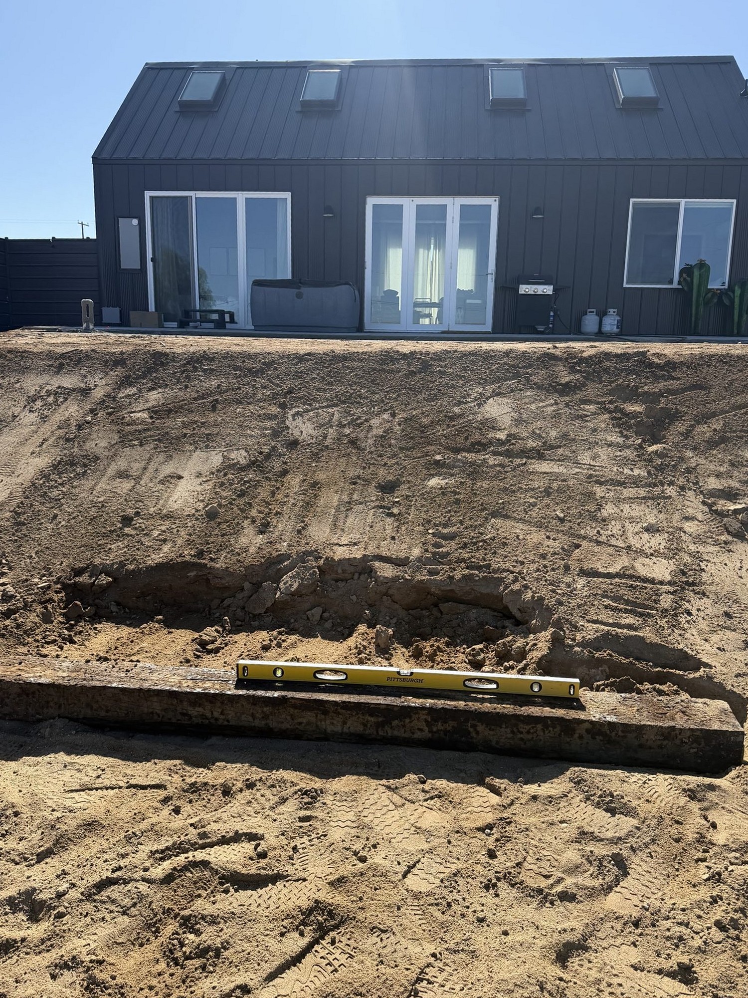 First timber tie levelled into a raw slope