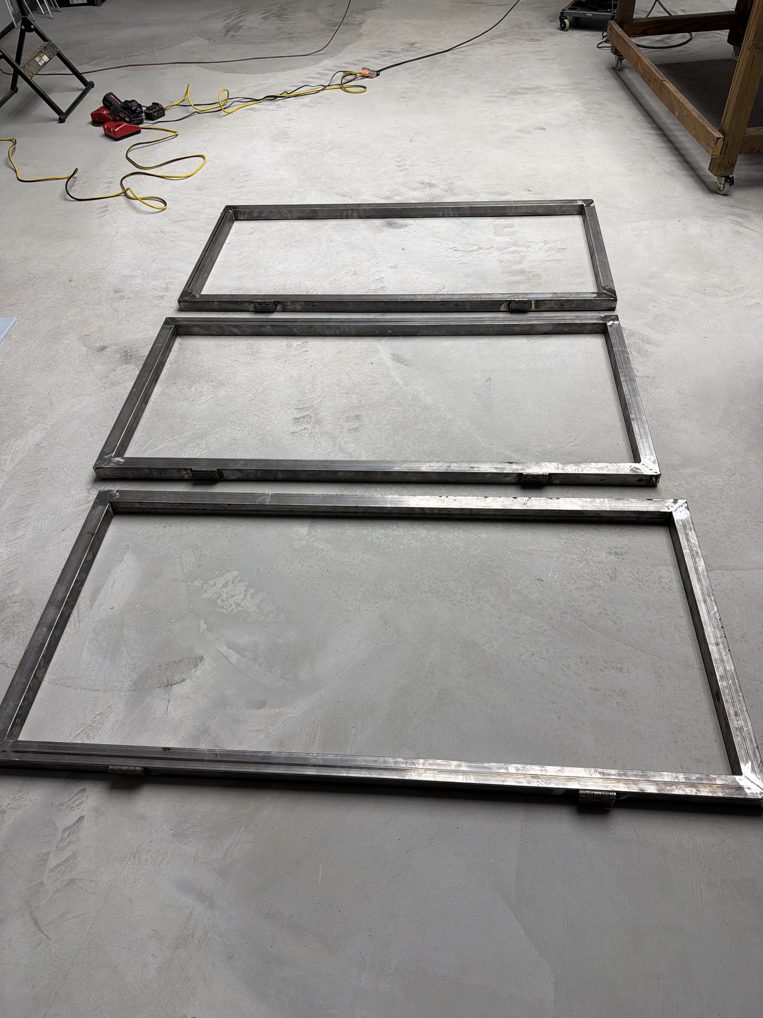 Welded steel panel frames laid out on the shop floor