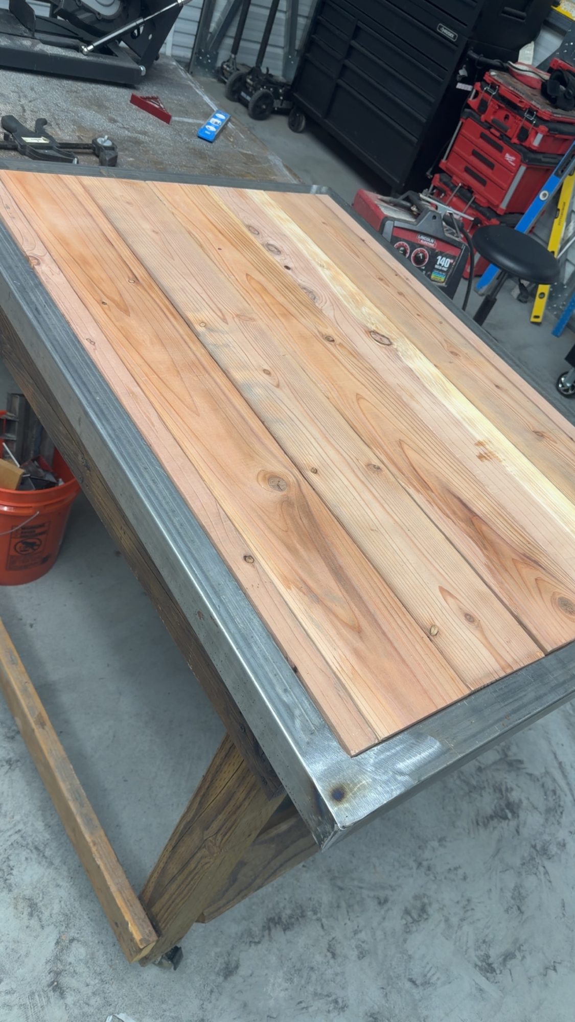 Steel-framed table with a cedar plank top in the shop